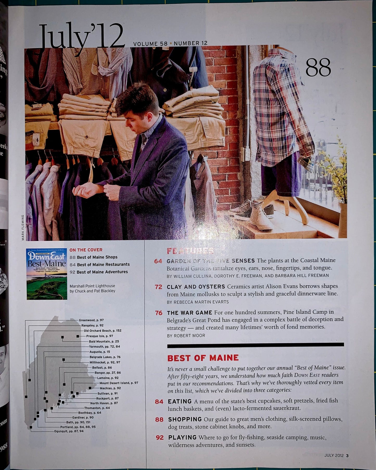 A printed magazine or travel feature page from July 12, Volume 88, Number 12, showing a large photo of people walking through a market, with text sections including features, in the cover, and best of Maine. The page is photographed flat against a white background.
[additional_image_link]