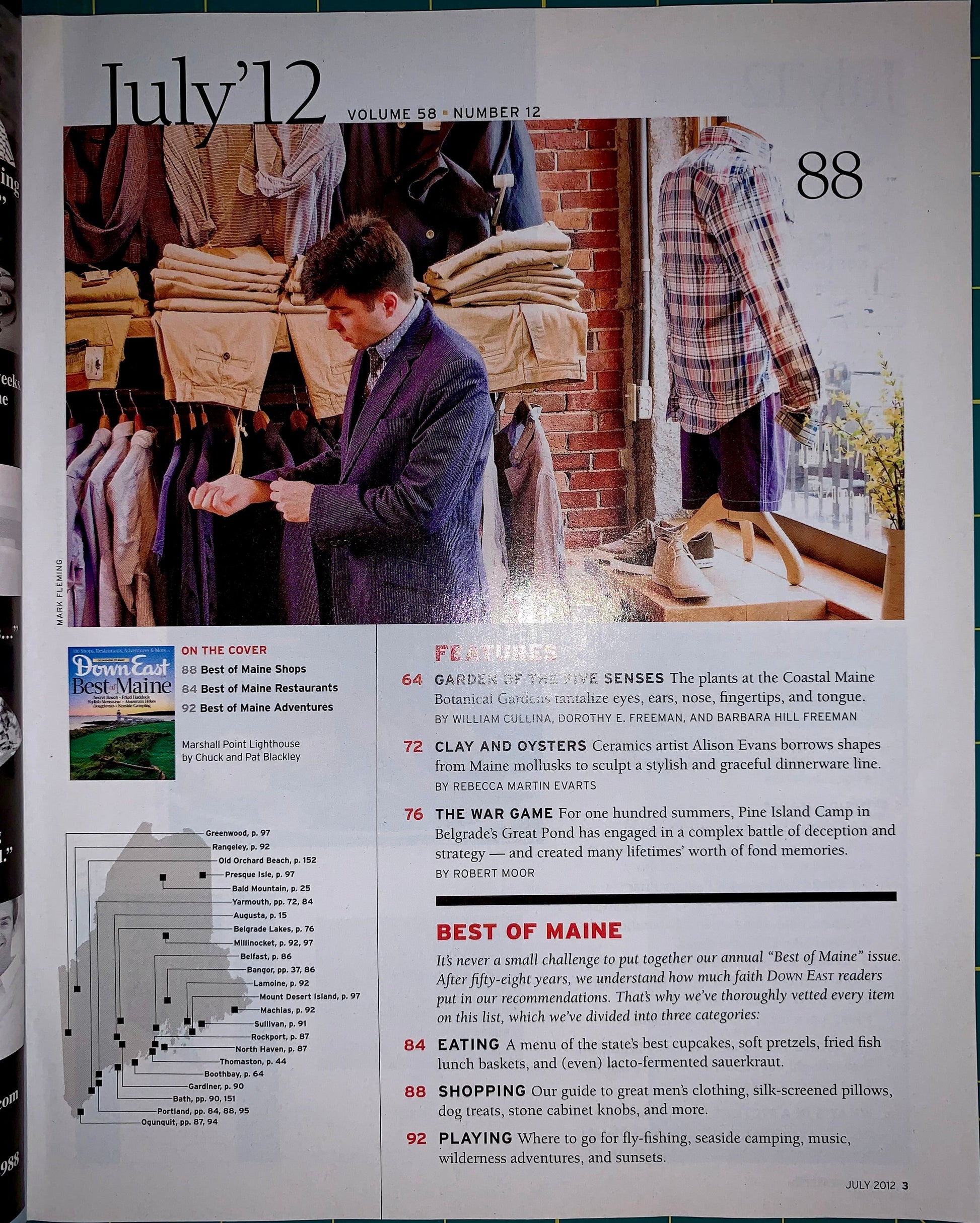 A printed magazine or travel feature page from July 12, Volume 88, Number 12, showing a large photo of people walking through a market, with text sections including features, in the cover, and best of Maine. The page is photographed flat against a white background.
[additional_image_link]