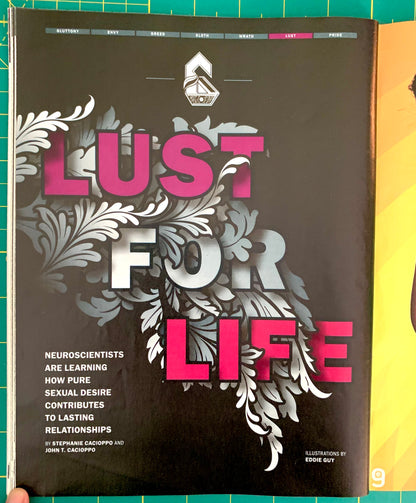 A book titled 'Lust for Life' by Stephanie Cacoppo and John T. Scaparro, featuring a black cover with bold pink and white typography and ornate silver leaf illustrations, photographed on a green cutting mat.
[additional_image_link]