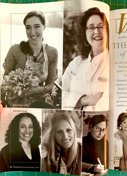 An open printed magazine or book spread showing several black-and-white portrait photos of women, with partial article text on the right page and a green cutting mat visible around the edges.
[additional_image_link]
