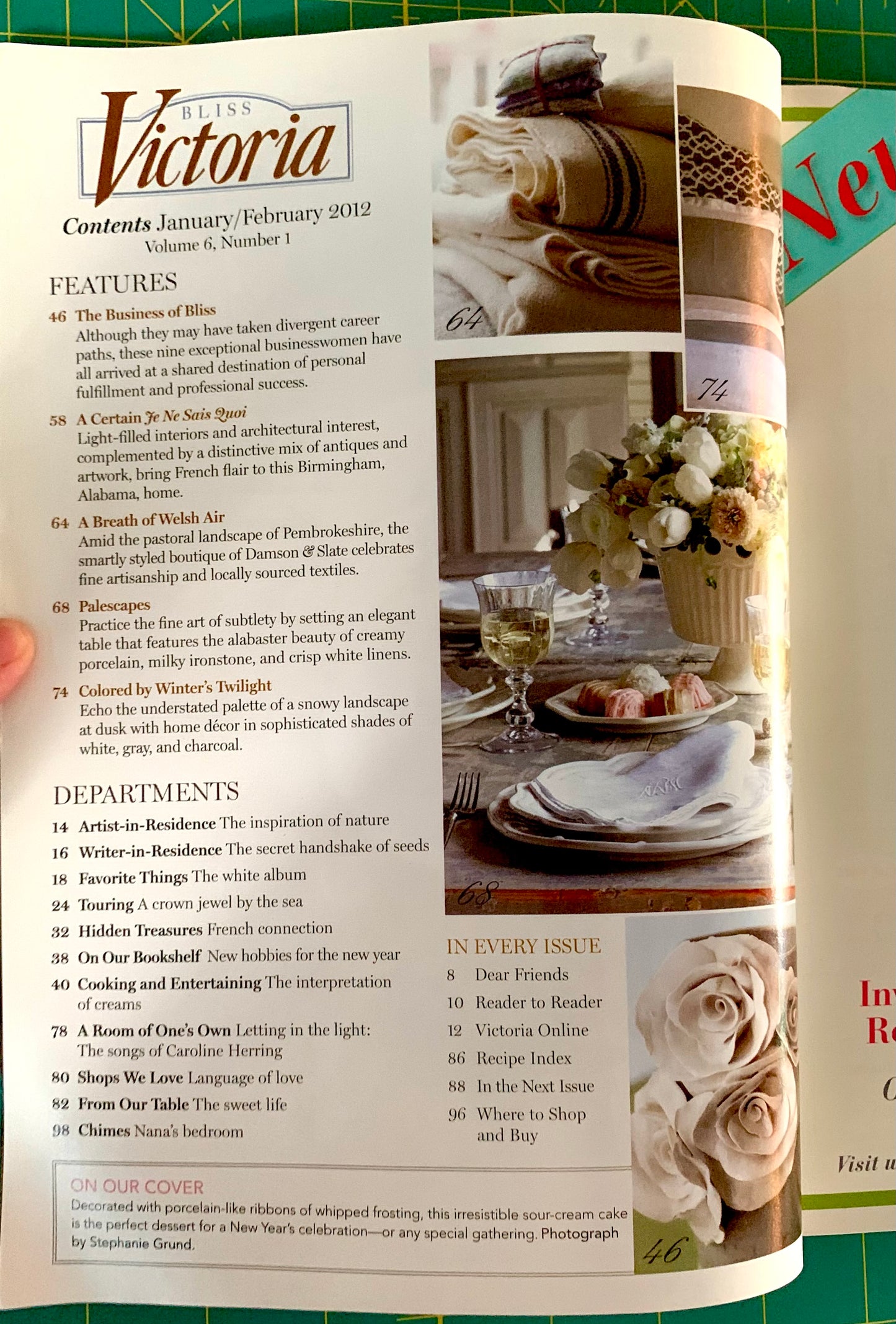 An open magazine or book spread showing a printed interior page with the title 'Victoria' at the top, a large cover photo of a chocolate-covered pastry, a table of contents, and a sidebar about the inside issue. A green cutting mat is visible around the edges.
[additional_image_link]