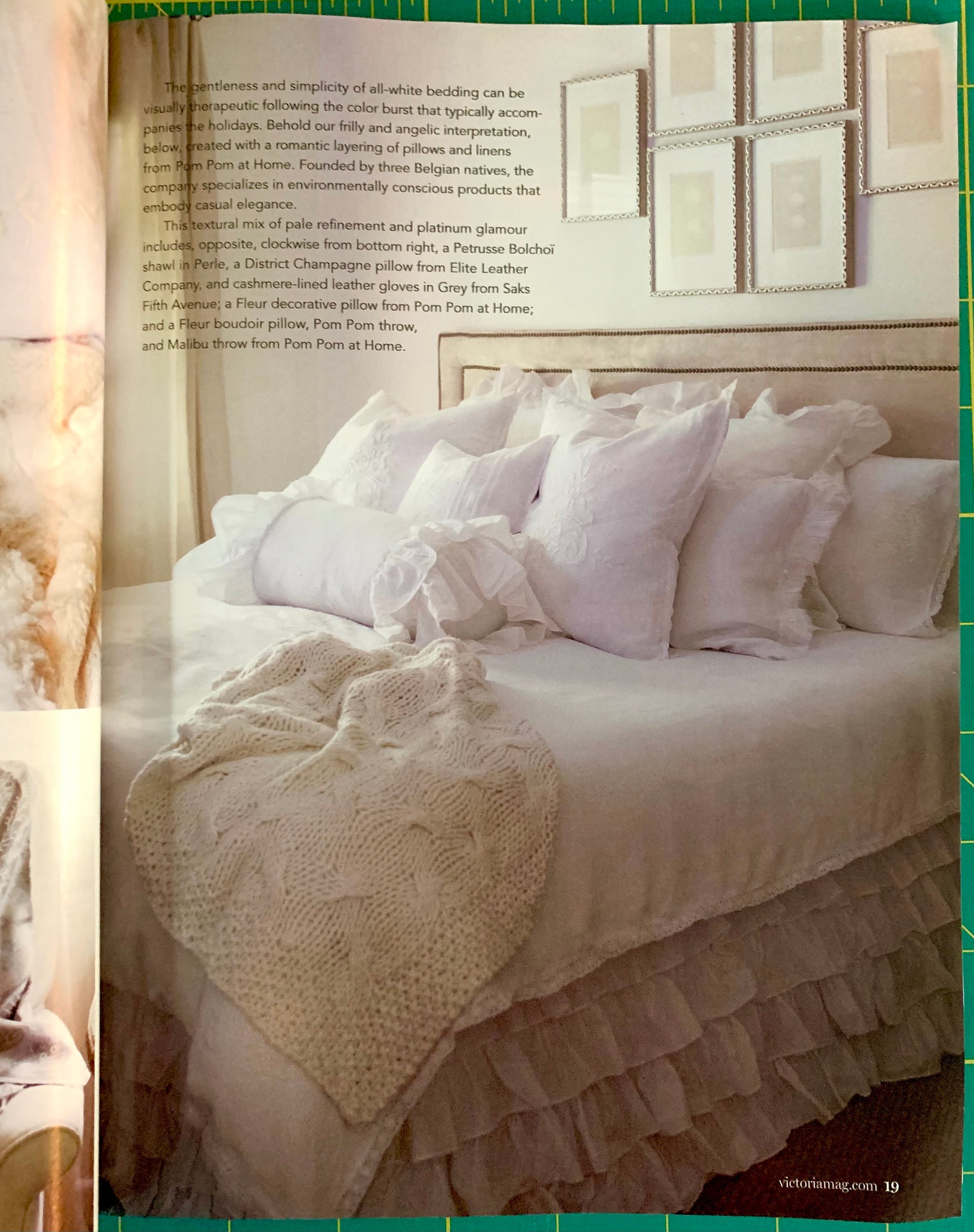 An open magazine or catalog page showing a styled bed with white bedding, multiple pillows, and a textured throw blanket. The page includes a block of text on the left and a green border around the photo.
[additional_image_link]