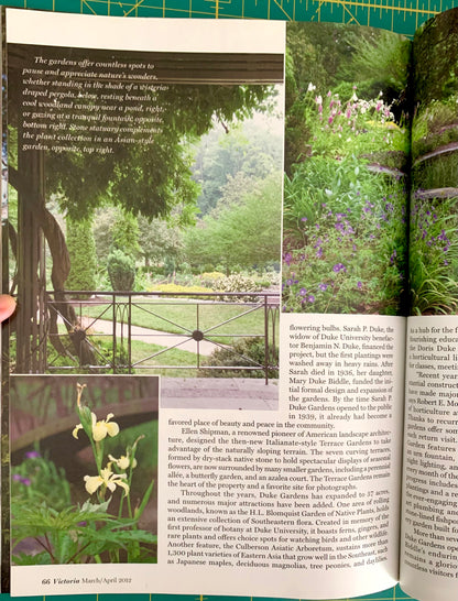 An open book showing a garden landscape photograph on the left page and text with a smaller inset photo on the right page, photographed against a green cutting mat background.
[additional_image_link]