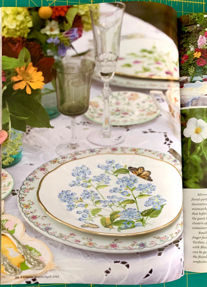 Table set with flowers and  floral china and goblets and silverware
[additional_image_link]