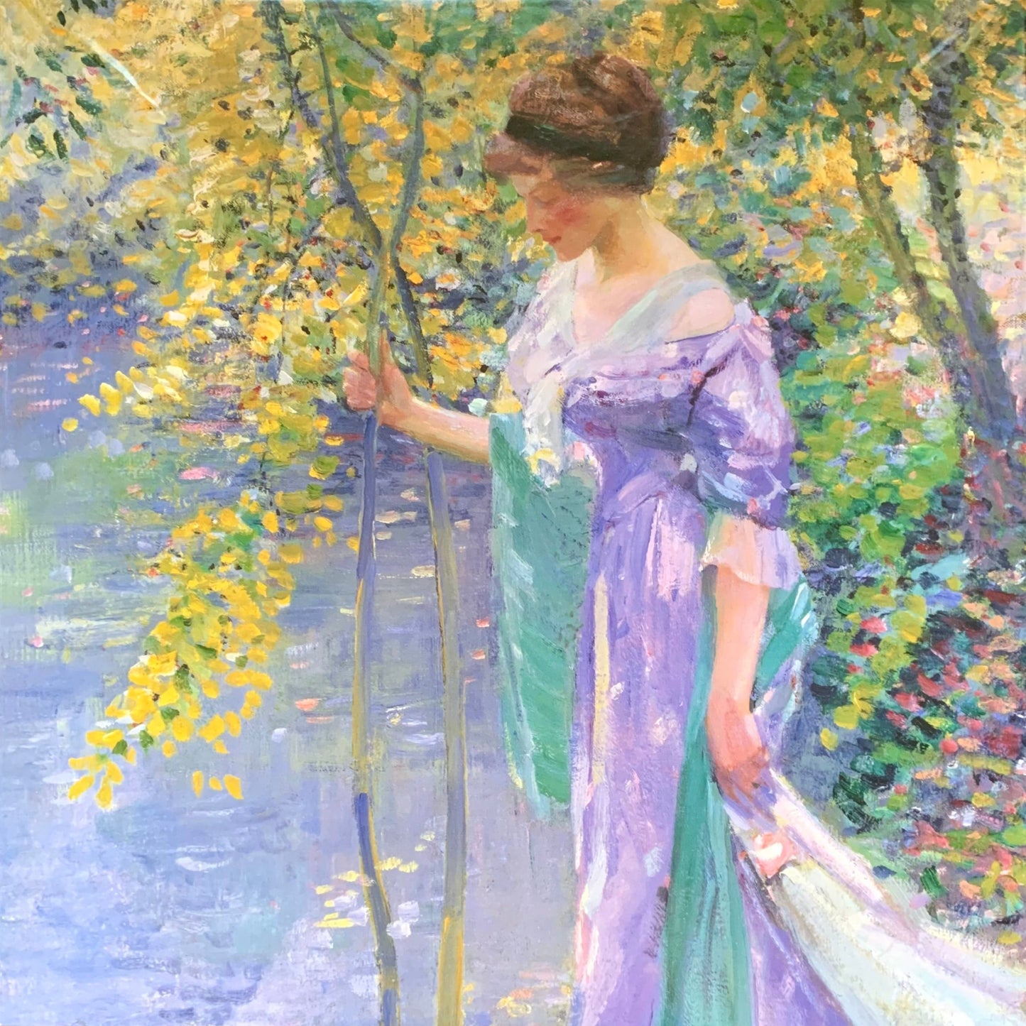 A jigsaw puzzle depicting a woman in a purple dress standing at a water's edge in a garden setting, with green and yellow colors in the background.
Photo by Karen King [image_link]