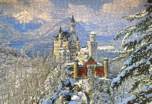 A wooden jigsaw puzzle depicting a winter scene with Neuschwanstein Castle, featuring a mix of shaped and irregular pieces.
Photo by Karen King [image_link]