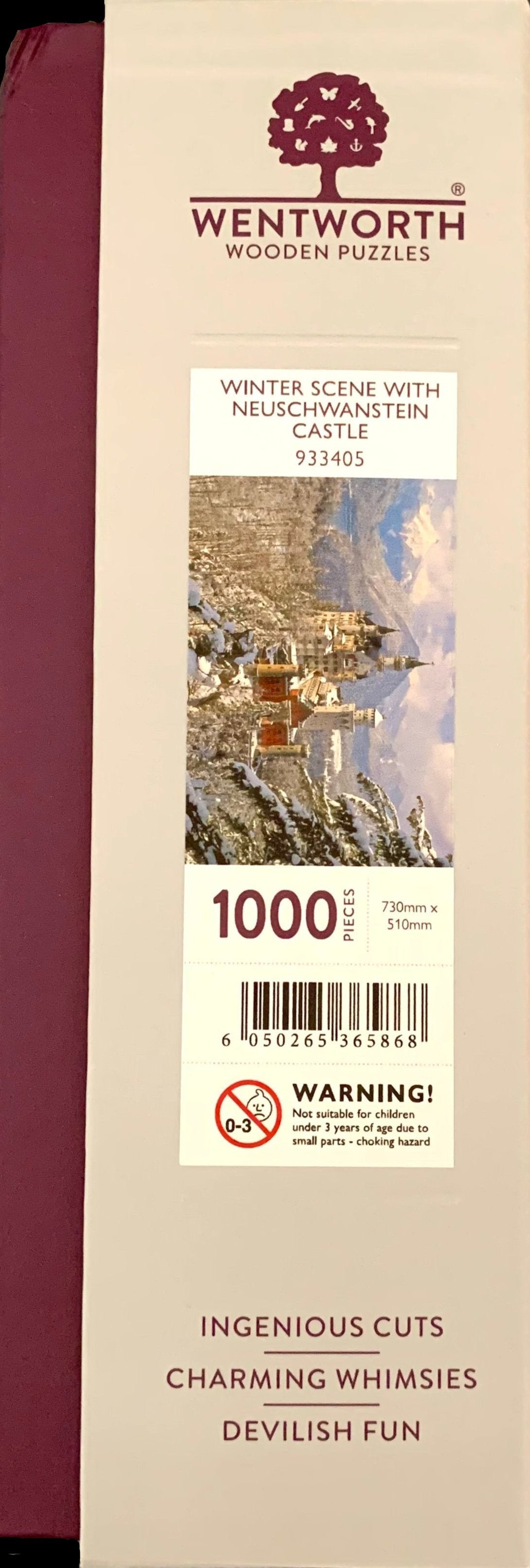 A wooden jigsaw puzzle depicting a winter scene with Neuschwanstein Castle, featuring a mix of shaped and irregular pieces.
Photo by Karen King [additional_image_link]