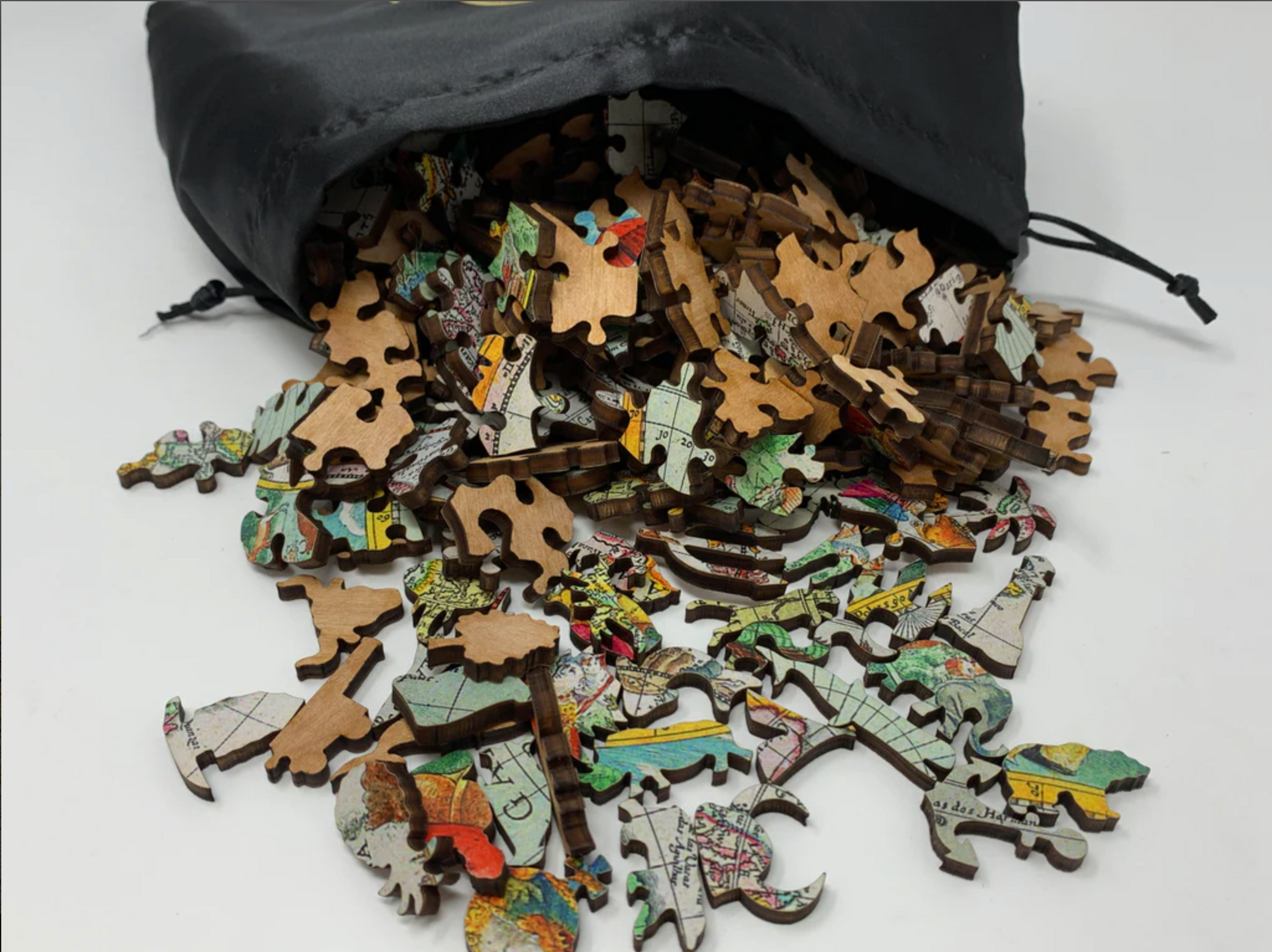 A completed wooden jigsaw puzzle depicting a world map, featuring various stylized countries and a compass in the center.
Photo by Nautilus Puzzles [additional_image_link]