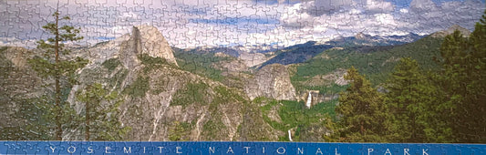 A jigsaw puzzle depicting a panoramic view of Yosemite National Park with green trees and rock formations.
Photo by Karen King [image_link]