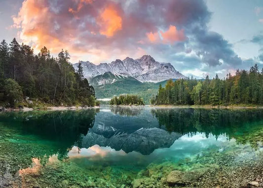 Mountain landscape with a lake and trees under a colorful sky.
Photo by Ravensburger [image_link]