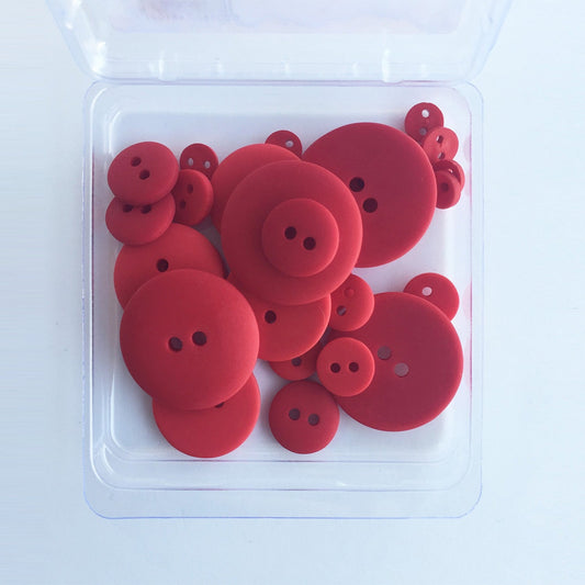 A clear plastic container holding 25 red, solid-colored buttons of varying sizes.
Photo by JustAnotherButtonCompany.com [image_link]
