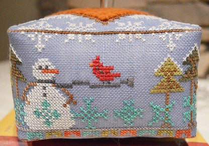 Cross-stitched box with winter scene featuring a snowman, cardinal, and trees.
Photo by HandsOnDesign.biz [additional_image_link]