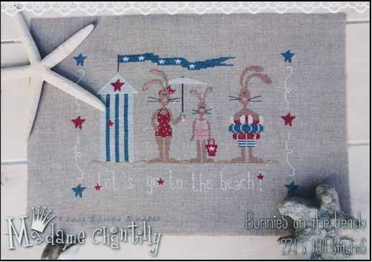 Cross stitch kit depicting three rabbits on a beach background with stars and stripes, likely intended for a craft or embellishment project.
Photo by Madame Chantilly [image_link]
