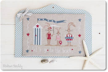 Cross stitch kit depicting three rabbits on a beach background with stars and stripes. Mounted on a polka dot board background and a ribbon.
Photo by Madame Chantilly [additional_image_link]