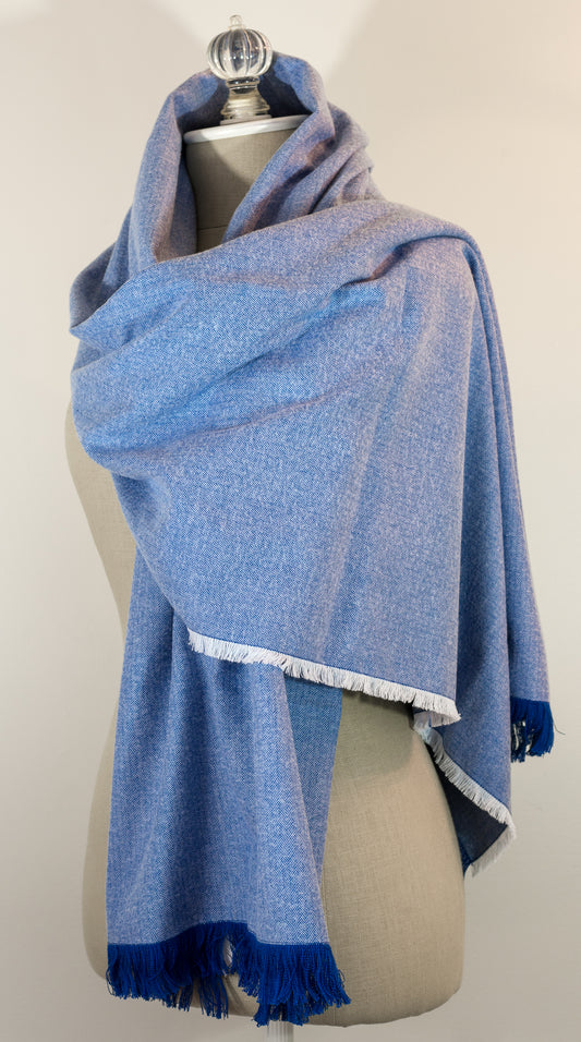 A blue herringbone flannel blanket scarf displayed on a mannequin, with the texture of the fabric visible. It has a fringe and appears to be a warm-colored accessory suitable for winter.
Photo by Karen King  [image_link]