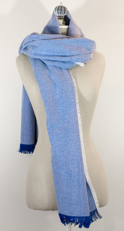 A blue herringbone flannel blanket scarf displayed on a mannequin, with the texture of the fabric visible. It has a fringe and appears to be a warm-colored accessory suitable for winter.
Photo by Karen King  [additional_image_link]