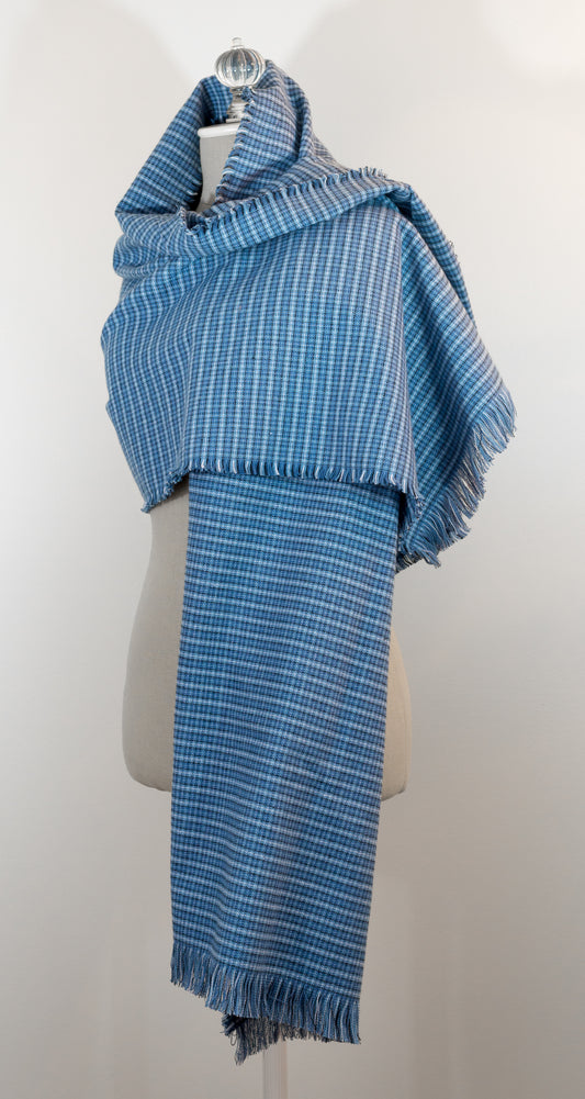A blue tartan plaid flannel blanket scarf draped over a mannequin bust.
Photo by Karen King  [image_link]