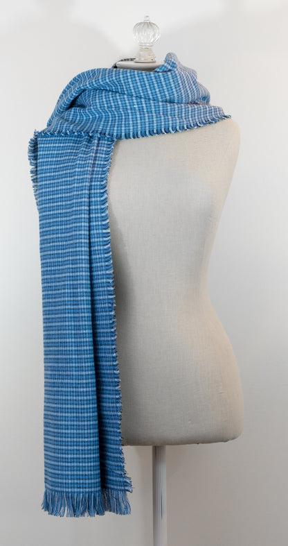 A blue tartan plaid flannel blanket scarf draped over a mannequin bust.
Photo by Karen King  [additional_image_link]