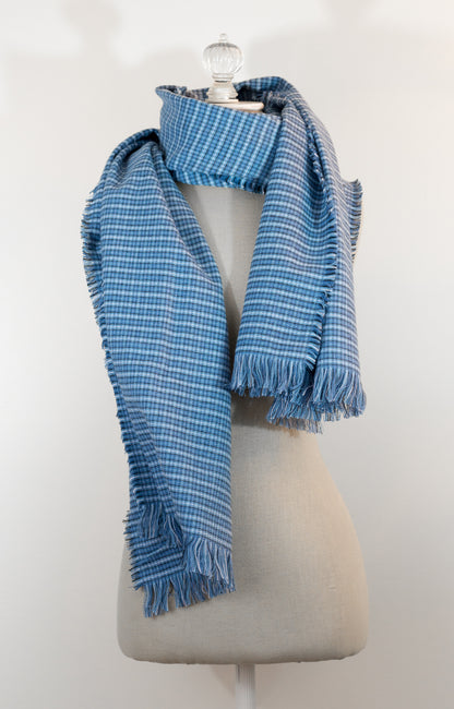 A blue tartan plaid flannel blanket scarf draped over a mannequin bust.
Photo by Karen King  [additional_image_link]