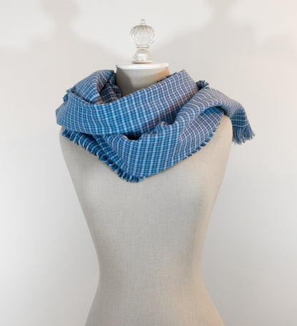 A blue tartan plaid flannel blanket scarf draped over a mannequin bust.
Photo by Karen King  [additional_image_link]