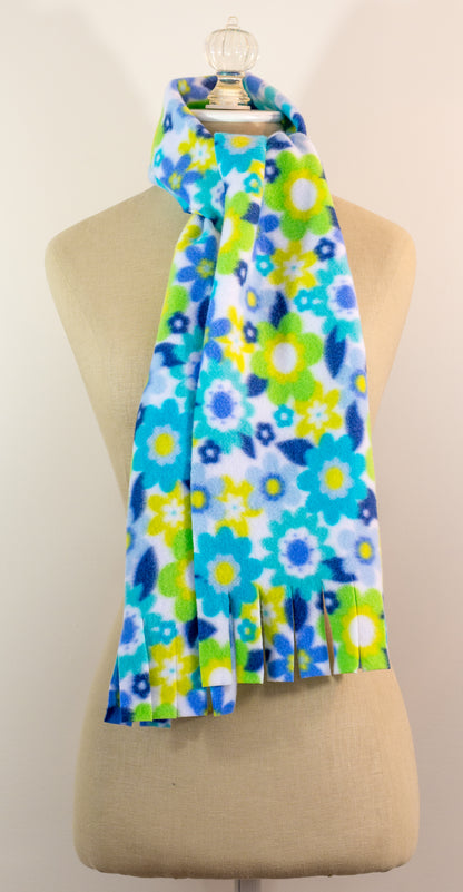 A blue and yellow floral polar fleece scarf with fringe displayed on a mannequin.
Photo by Karen King [image_link]