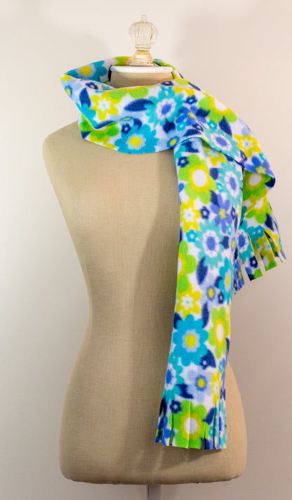 A blue and yellow floral polar fleece scarf with fringe displayed on a mannequin.
Photo by Karen King [additional_image_link]