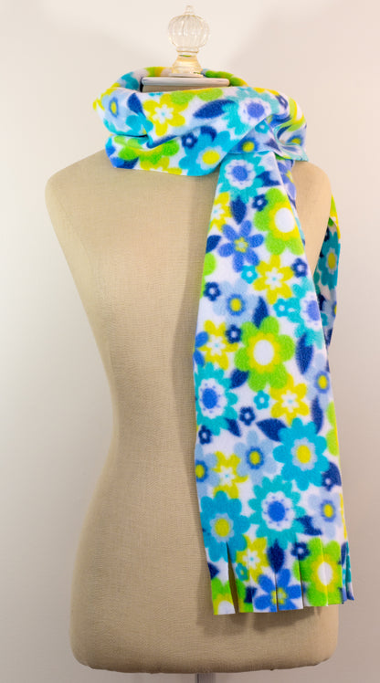 A blue and yellow floral polar fleece scarf with fringe displayed on a mannequin.
Photo by Karen King [additional_image_link]