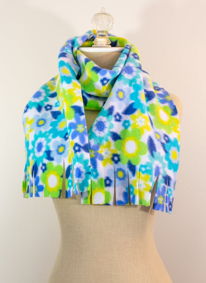 A blue and yellow floral polar fleece scarf with fringe displayed on a mannequin.
Photo by Karen King [additional_image_link]