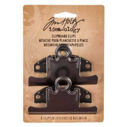 Two black Tim Holtz Ideaology clipboard clips attached to a tan cardboard backing card, photographed against a plain white background.
[additional_image_link]