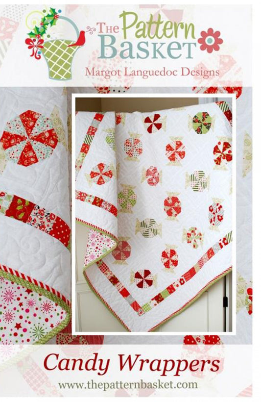 A quilt with a Christmas candy wrapper theme, featuring red and green fabrics with white background, and textured patterns. The quilt is folded to show the back, binding, and a corner detail, with a label indicating 'Candy Wrappers' and the designer's name.
Photo by ThePatternBasket.com [image_link]