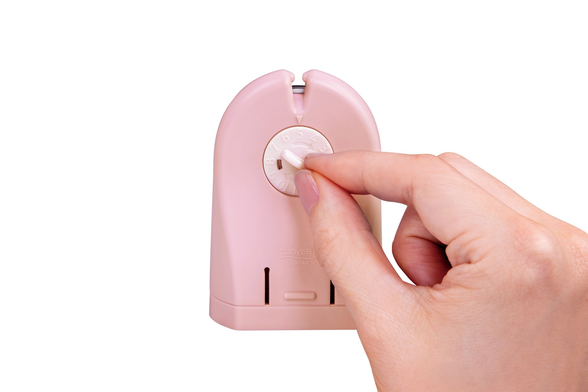 A close-up of a hand with pink manicured nails turning a white switch on a light pink electronic device, isolated on a white background.
Photo by Clover-USA.com [additional_image_link]