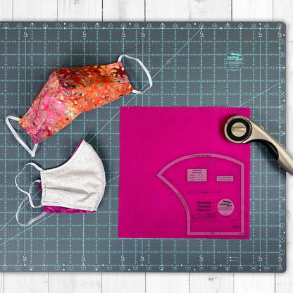 Two face masks and a pink cutting mat with a pattern on a grid surface.
Photo by Creative Grids [additional_image_link]