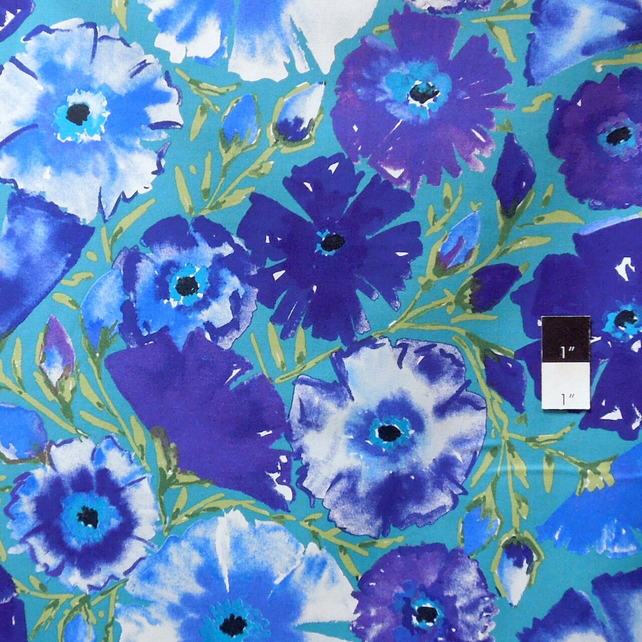A close-up of a watercolor floral pattern featuring blue, purple, and white flowers with yellow-green stems on a teal background.
[additional_image_link]