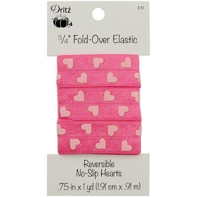 A piece of Dritz 3/4 inch fold over elastic ribbon in pink with heart patterns, packaged on a card showing the product details.
Photo by Dritz [image_link]