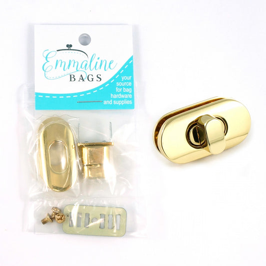 A gold finish small turn lock for bags and supplies packaged in a clear plastic bag, with a branded label on top.
[image_link]