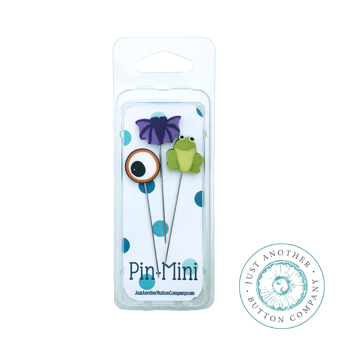 A packaged set of two mini decorative pins from Pin+Mini, featuring a purple butterfly and a green frog with one pin having a single large eye. The pins are displayed in a clear plastic blister pack with a white backing card decorated with blue polka dots, set against a plain white background with a brand watermark in the bottom right corner.
Photo by Just Another Button Company [additional_image_link]
