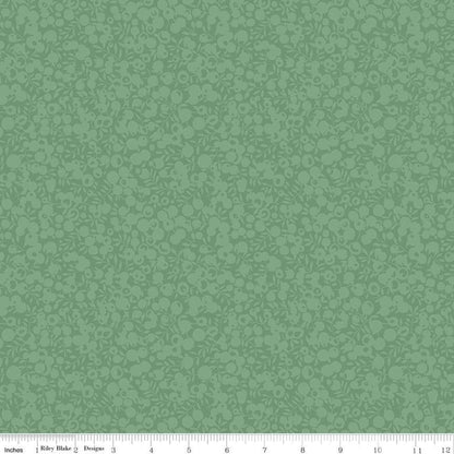 A close-up of a green fabric or wallpaper pattern swatch with a repeating floral and scroll motif, plus a ruler strip along the bottom edge showing measurements.
Photo by RileyBlakeDesigns.com [additional_image_link]