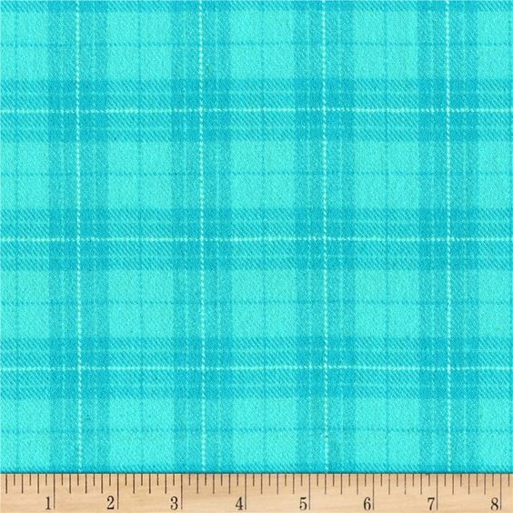 A close-up of a turquoise and teal plaid fabric pattern with a wooden ruler along the bottom edge showing measurement markings.
[additional_image_link]
