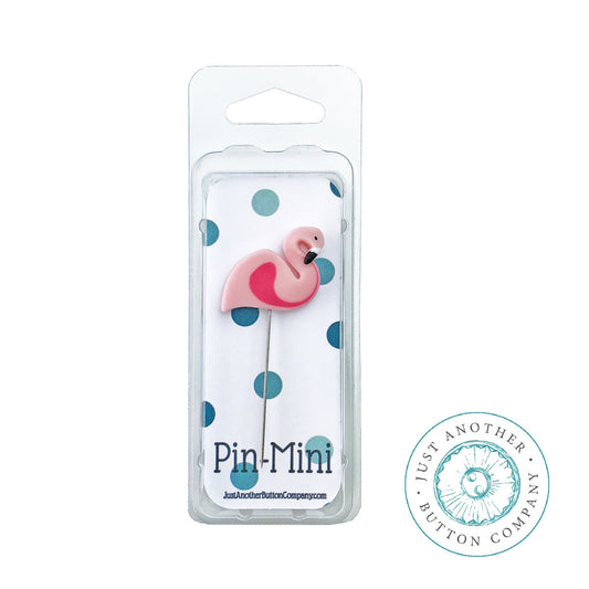 A pink flamingo-shaped pin in a clear blister pack with blue polka dots on a white backing card, labeled 'Pin-Mini' with the Just Another Button Company logo. A circular Just Another Button Company logo is also shown on the right.
Photo by JustAnotherButtonCompany.com [image_link]