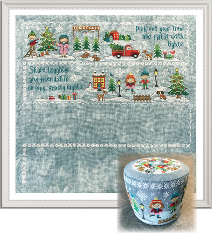 A framed winter-themed needlework or embroidery design with a snowy village scene, children, trees, a red truck, and decorative text, shown alongside a matching small cylindrical container with the same illustrated lid.
Photo by Tiny Modernist [additional_image_link]