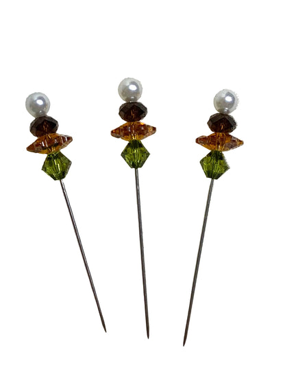 Three decorative hair pins with long dark metal stems, each topped with a white pearl bead, a faceted amber-brown bead, a faceted green bead, and a small faceted dark brown bead, shown on a plain white background.
[additional_image_link]