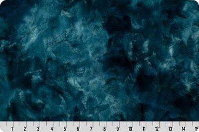 Dark teal blue marbled fabric texture with a white ruler at the bottom indicating scale.
Photo by Shannon Fabrics [additional_image_link]