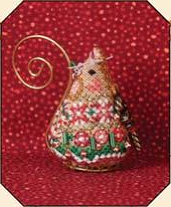 A completed gingerbread candy mouse ornament with red and white striped beads, green bugle beads, and a gold tail, against a red polka-dotted background.
Photo by JustNan.com [image_link]