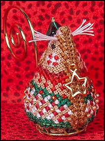 A cross-stitch embroidery kit depicting a gingerbread elf mouse with a gold hanger and adorned with beads.
Photo by JustNan.com [image_link]