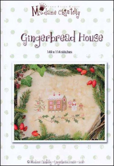 A cross stitch pattern depicting a gingerbread house with Christmas decorations, surrounded by pine needles and red berries.
Photo by madamechantilly.com [additional_image_link]