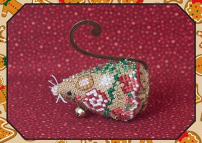 Cross stitch embroidery kit depicting a gingerbread jingle mouse with a green ribbon, gold swirl hanger, and red and green floral details, on a red background.
Photo by JustNan.com [additional_image_link]