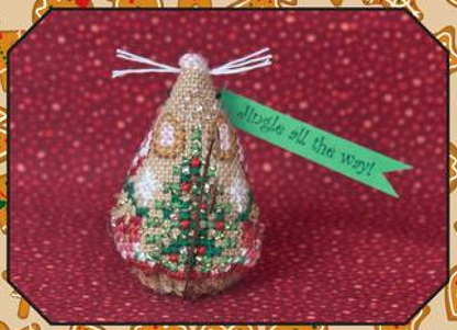 Cross stitch embroidery kit depicting a gingerbread jingle mouse with a green ribbon, gold swirl hanger, and red and green floral details, on a red background.
Photo by JustNan.com [additional_image_link]