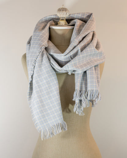 A gray, beige, and white plaid flannel scarf displayed on a mannequin bust, with fringed ends visible.
Photo by Karen King [additional_image_link]