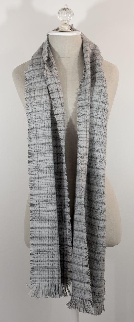 A gray tartan plaid flannel scarf with fringe, displayed on a mannequin.
Photo by Karen King  [image_link]