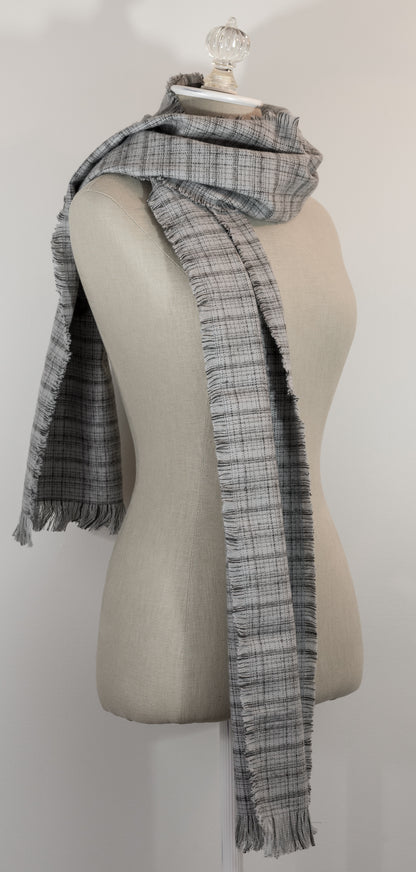 A gray tartan plaid flannel scarf with fringe, displayed on a mannequin.
Photo by Karen King  [additional_image_link]